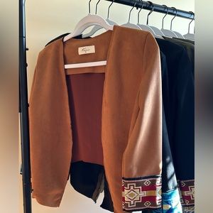 Handmade suede jackets with Latin American embroidered cuffs, made in Ecuador.